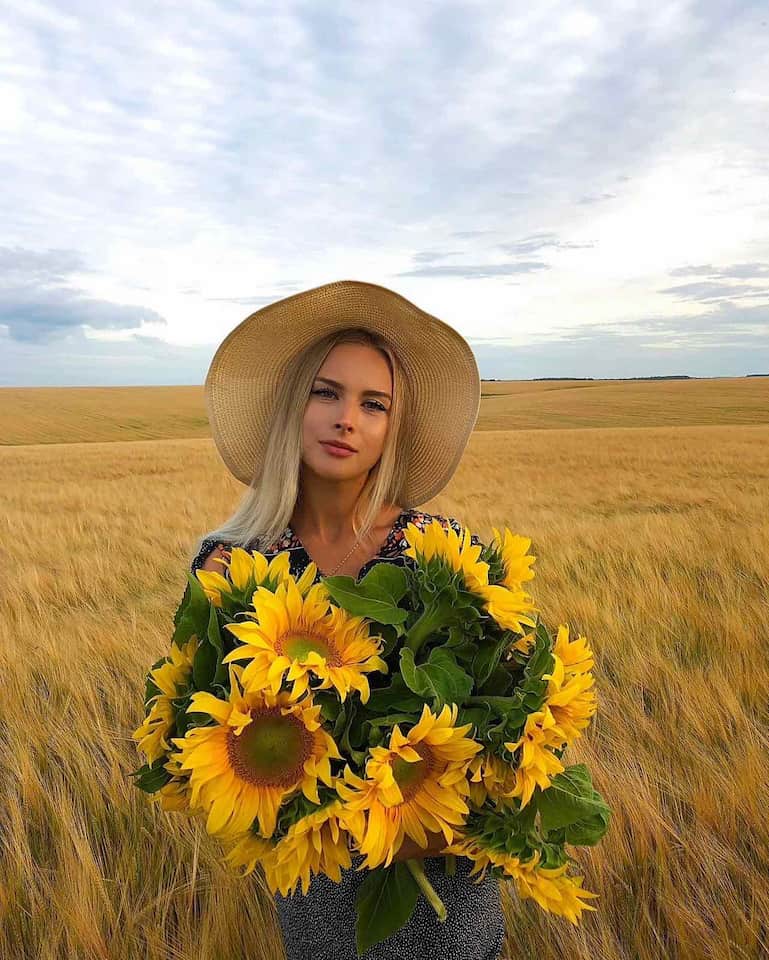 Девушка с подсолнухами на пшеничном поле